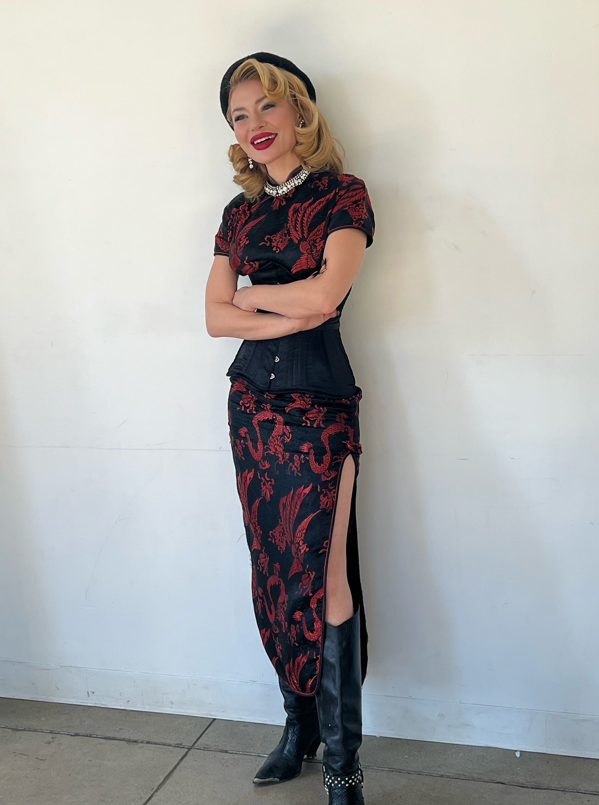 Chelsea Volpe in a black and red brocade dress