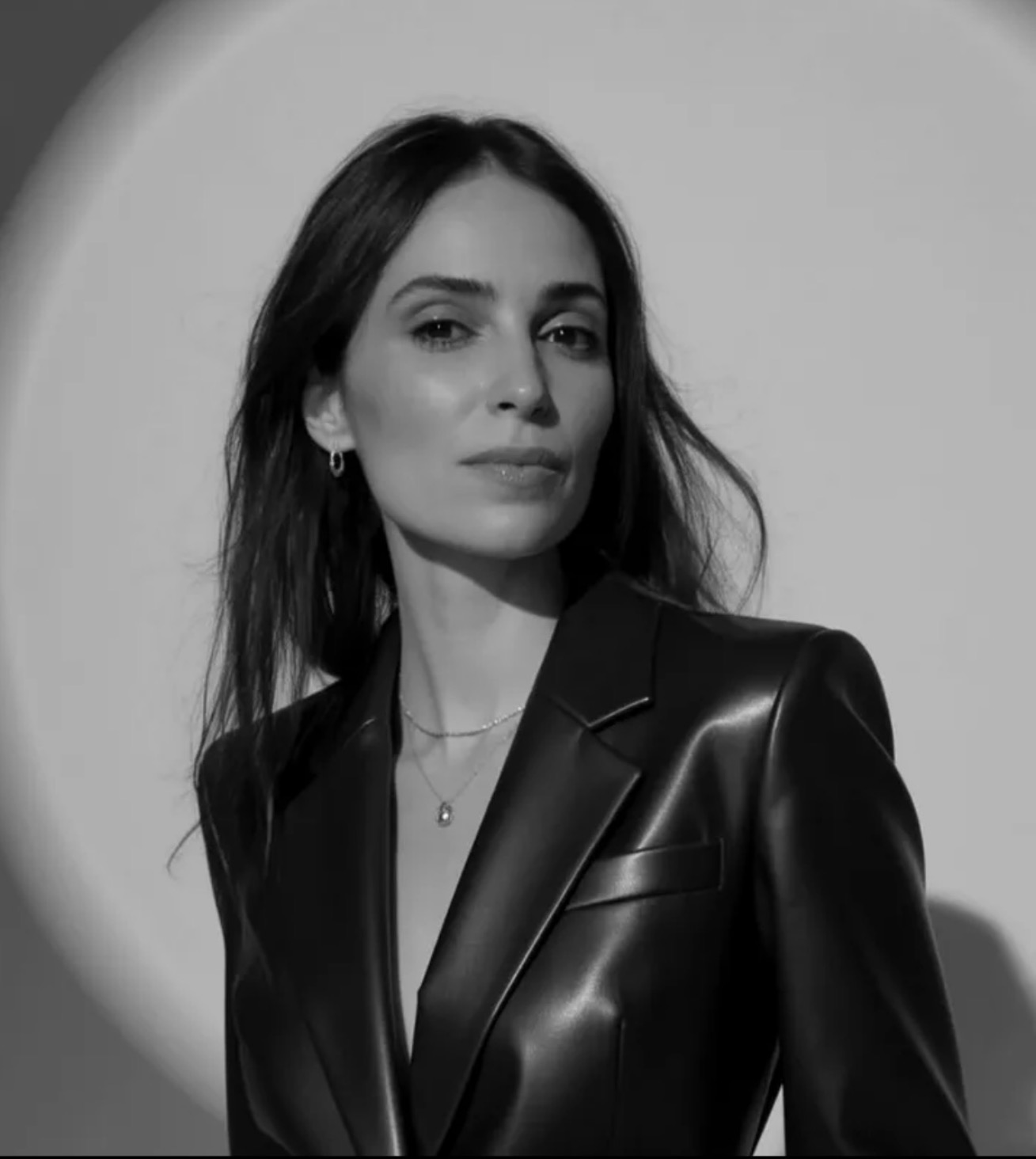 Shannon in a black-and-white portrait wearing a leather blazer